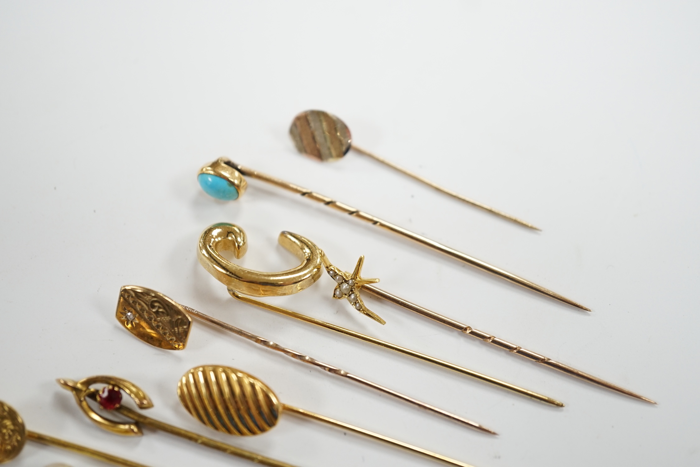 Fifteen assorted mainly early 20th century yellow metal and gem set stick pins, including diamond, seed pearl and banded agate, gross weight 23.1 grams.